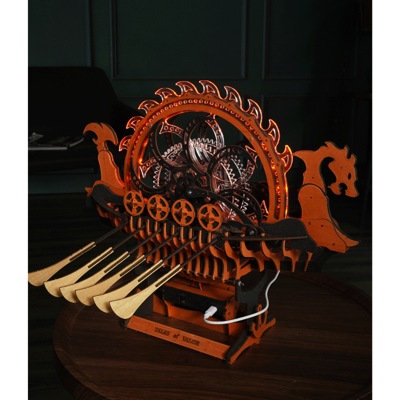 Puzzle 3D Viking Dragon Ship illuminé montrant ses engrenages mécaniques et sa structure orange et noire.